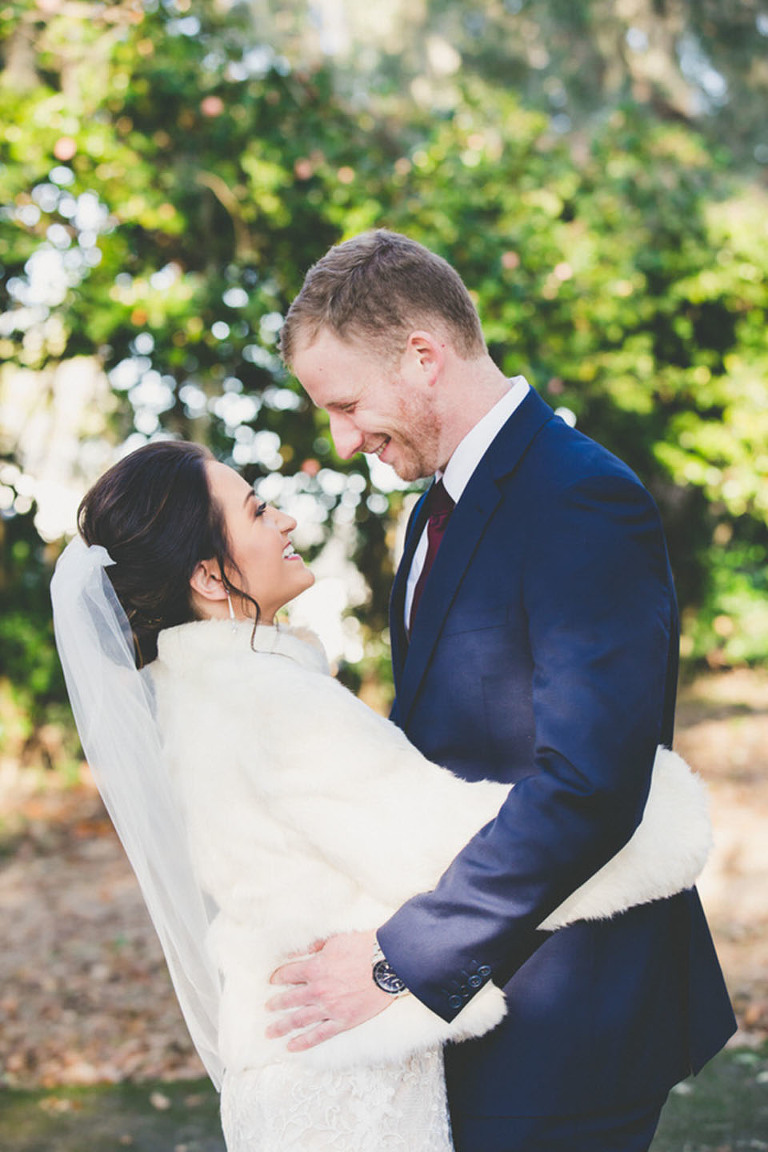 bride and groom smiling at each other