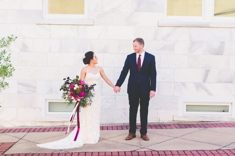 bride and groom holding hands
